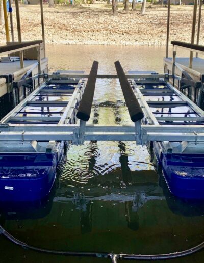 Shallow water boat lift installed in a boat slip